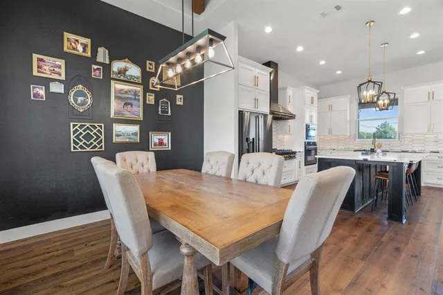 a kitchen with a sink appliances and wooden floor