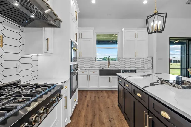 a kitchen with stainless steel appliances a stove and a microwave