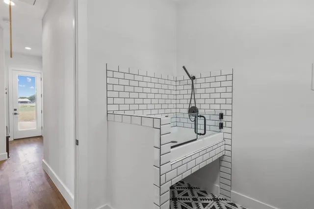 a bath room with a sink and a mirror