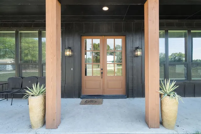 a view of an entryway with wooden floor and door