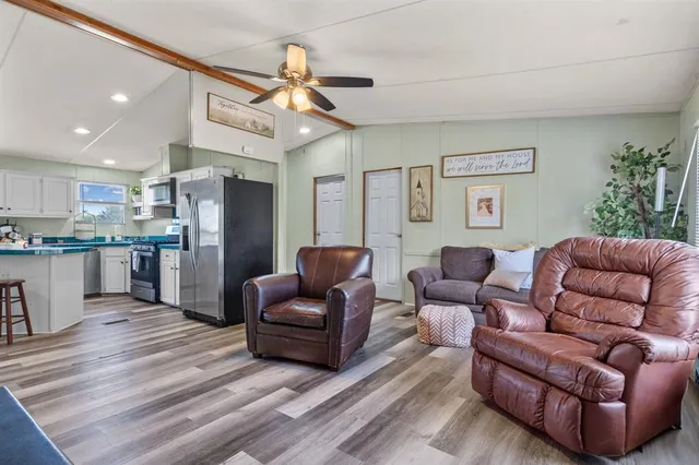 a bathroom with a granite countertop toilet sink and mirror