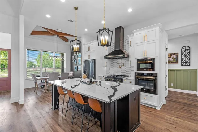 a kitchen with a counter space a sink appliances and cabinets