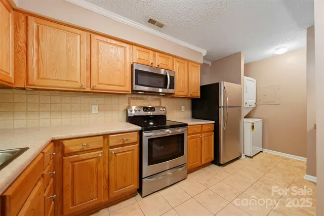 a kitchen with stainless steel appliances granite countertop a refrigerator stove and microwave