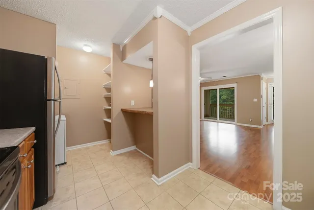 a view of a kitchen with a refrigerator and a sink