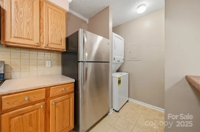 a white refrigerator freezer and a stove sitting inside of a kitchen