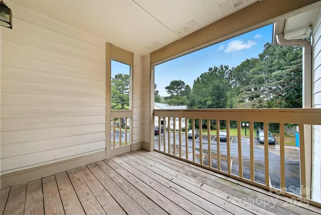 a view of a balcony with wooden floor