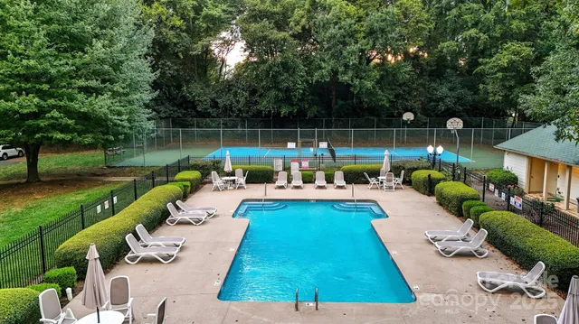 a view of swimming pool with a patio and a garden