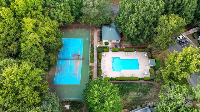 an aerial view of a house with a yard swimming pool and outdoor seating