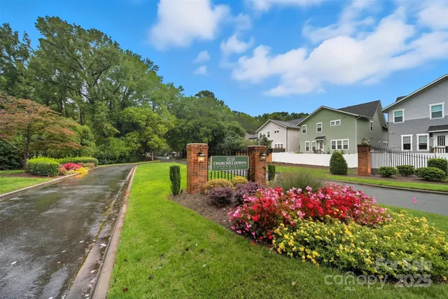 a view of a house with a big yard and large trees