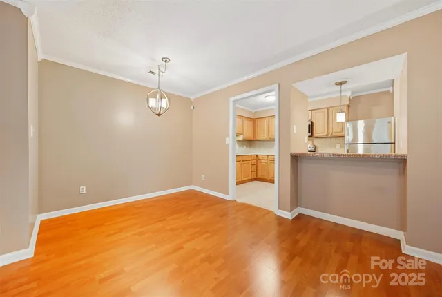 a view of a kitchen with wooden floor and a kitchen