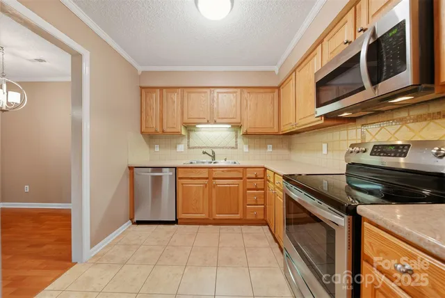 a kitchen with a sink stove and microwave