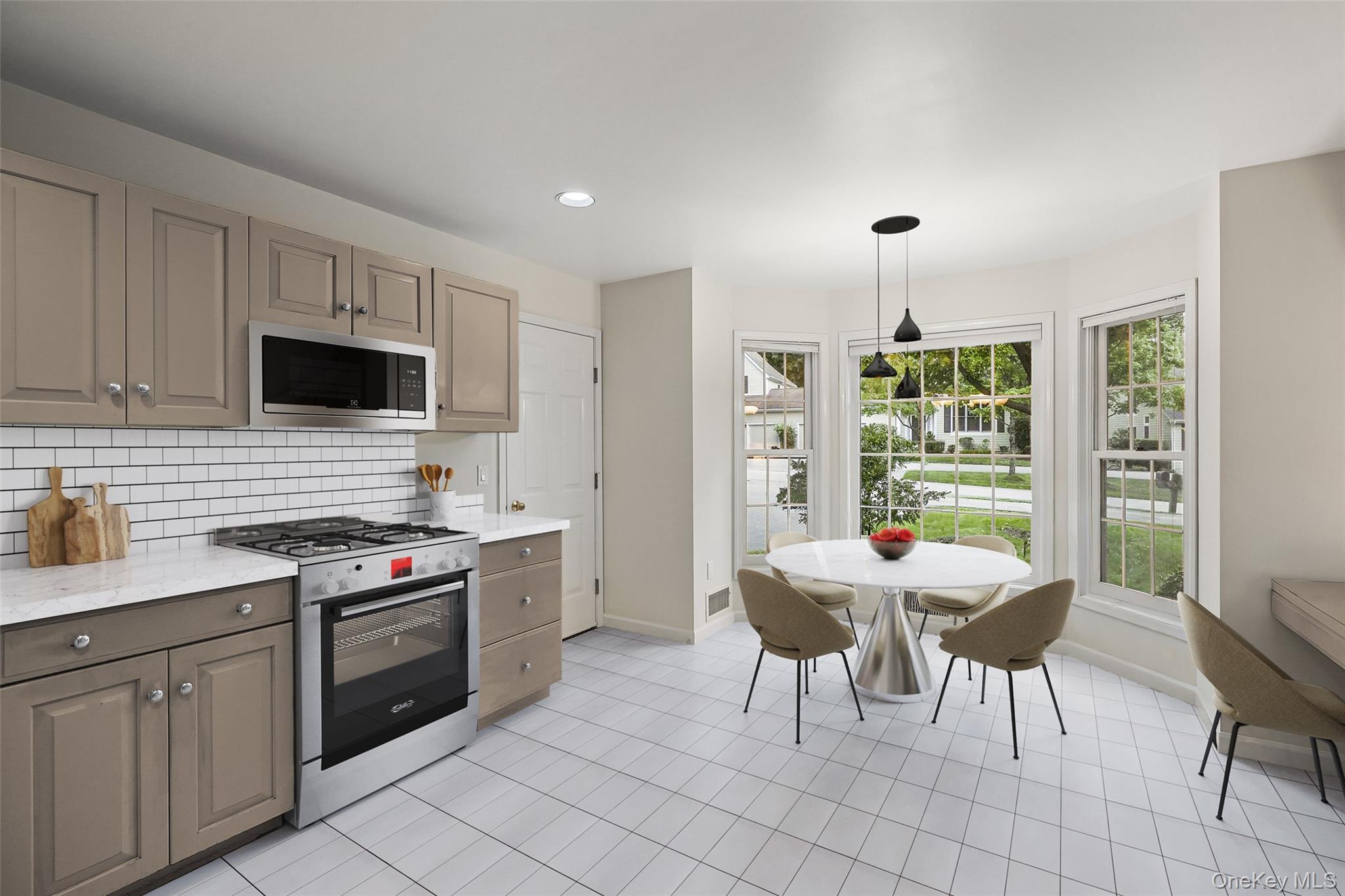 18 Cross River Road Mount Kisco, NY 10549 - Photo 12 of 30 a kitchen with stainless steel appliances granite countertop a stove a sink dishwasher a dining table and chairs with wooden floor