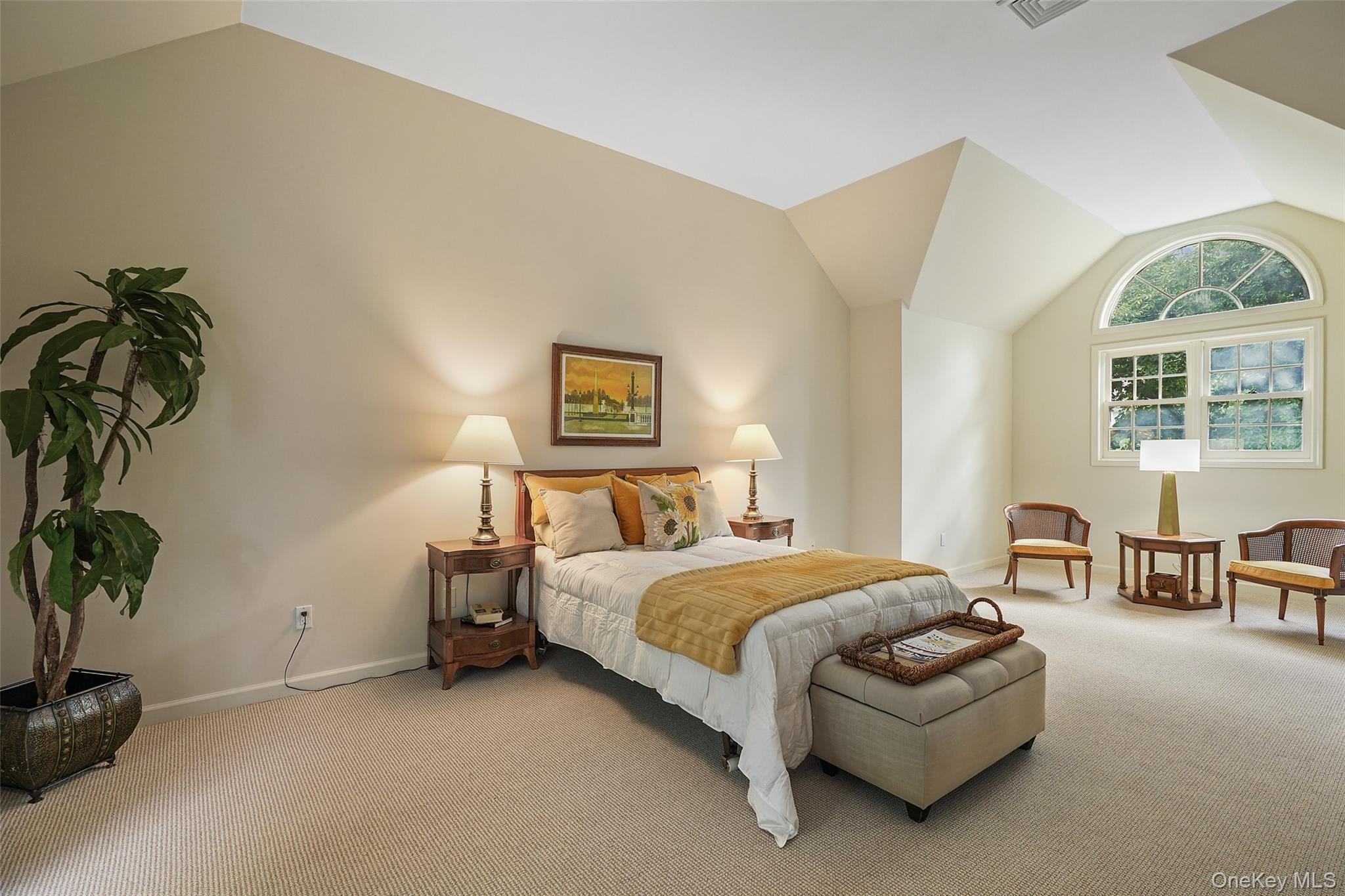 18 Cross River Road Mount Kisco, NY 10549 - Photo 15 of 30 a bedroom with a bed and a potted plant