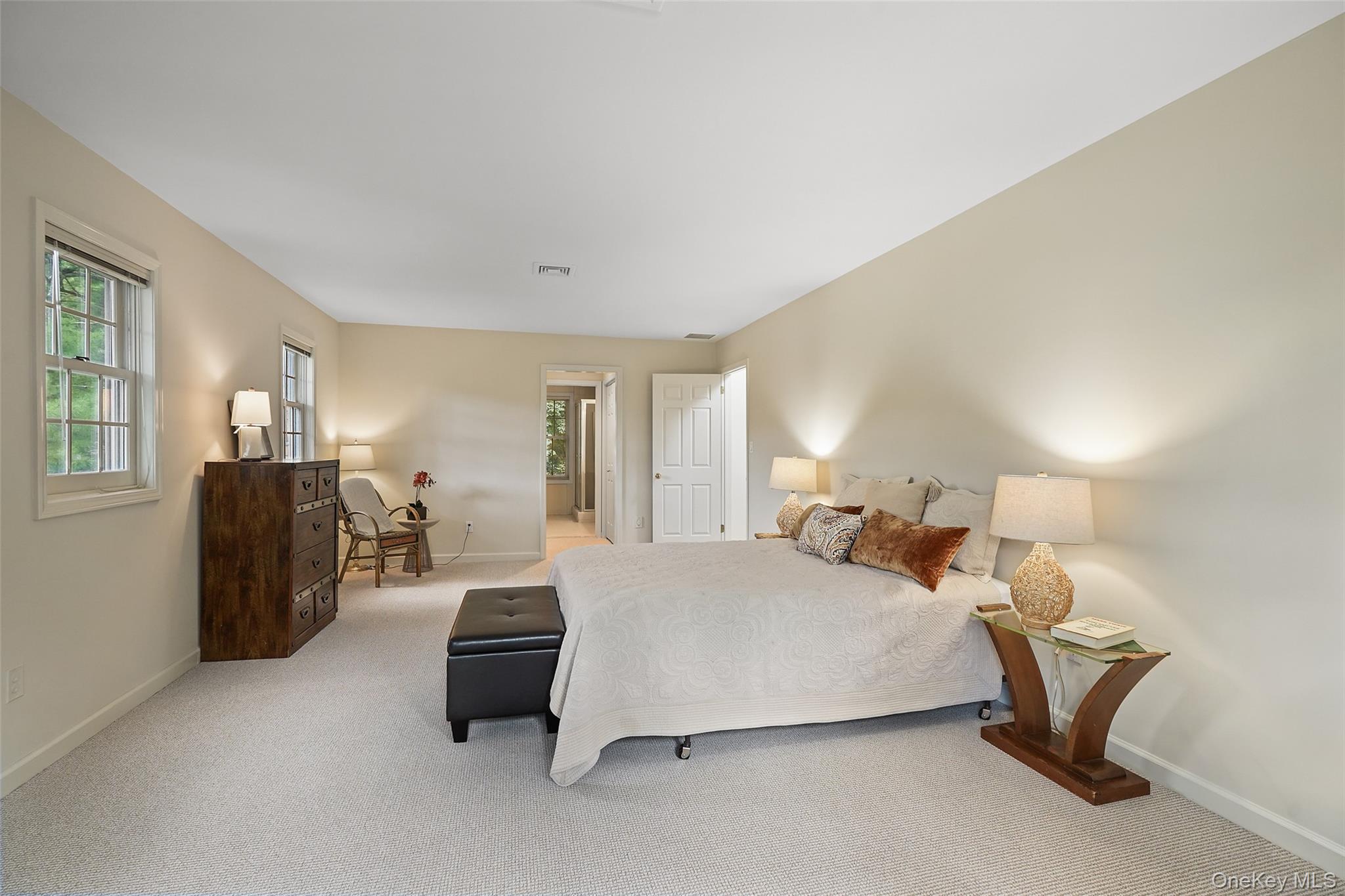 18 Cross River Road Mount Kisco, NY 10549 - Photo 20 of 30 a bedroom with a bed and a chandelier