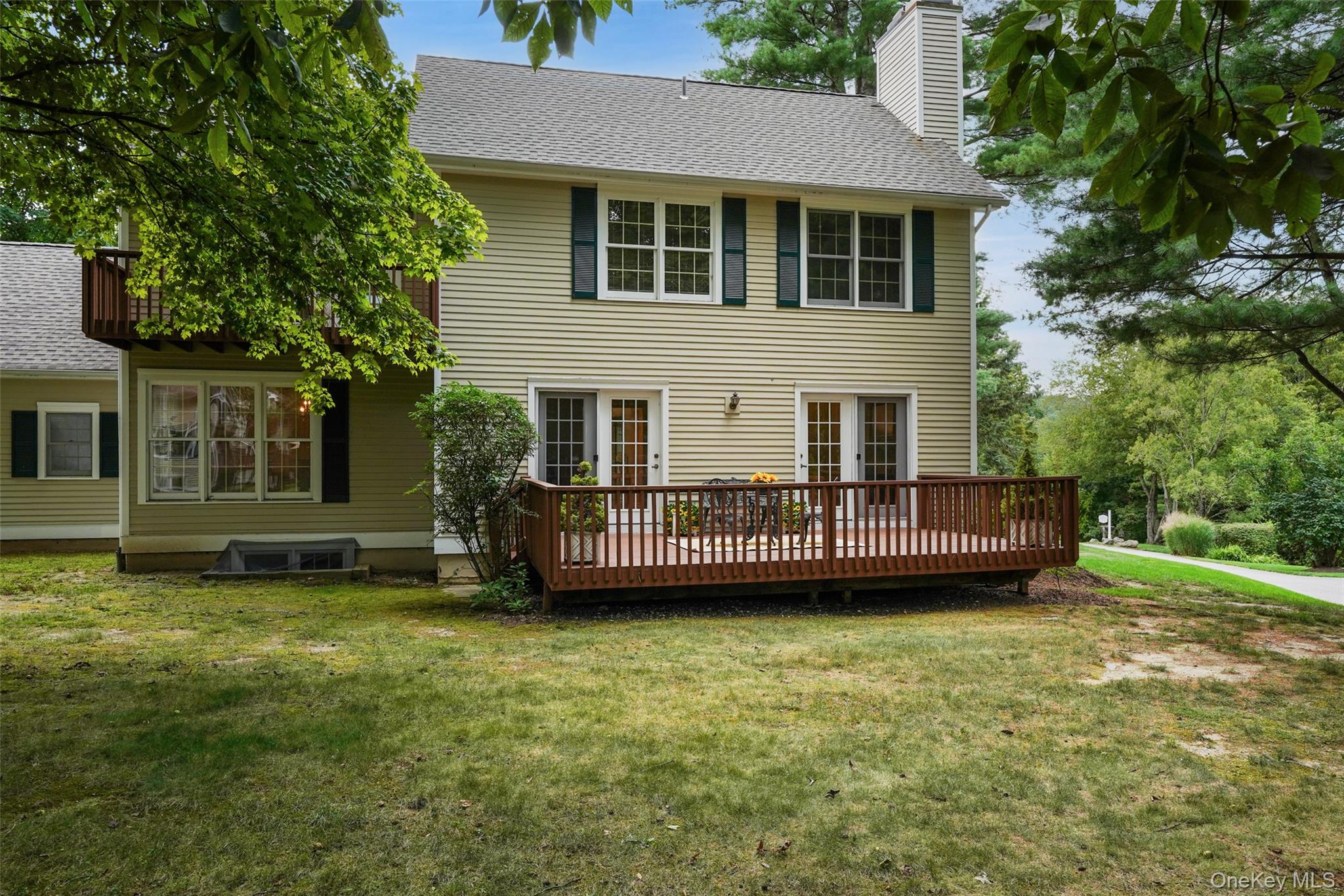 18 Cross River Road Mount Kisco, NY 10549 - Photo 23 of 30 a view of a house with a garden and deck