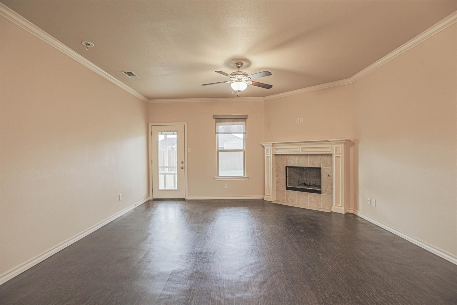 5019 Jarvis Street Lubbock, TX 79416 - Photo 11 of 31 an empty room with windows fireplace and a sink