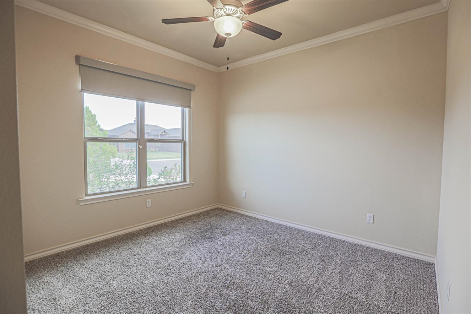 5019 Jarvis Street Lubbock, TX 79416 - Photo 14 of 31 an empty room with windows and fan