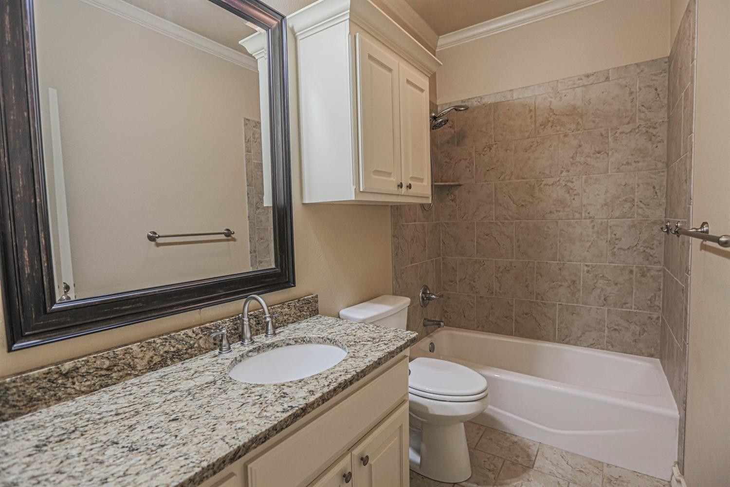 5019 Jarvis Street Lubbock, TX 79416 - Photo 15 of 31 a bathroom with a granite countertop sink toilet and shower