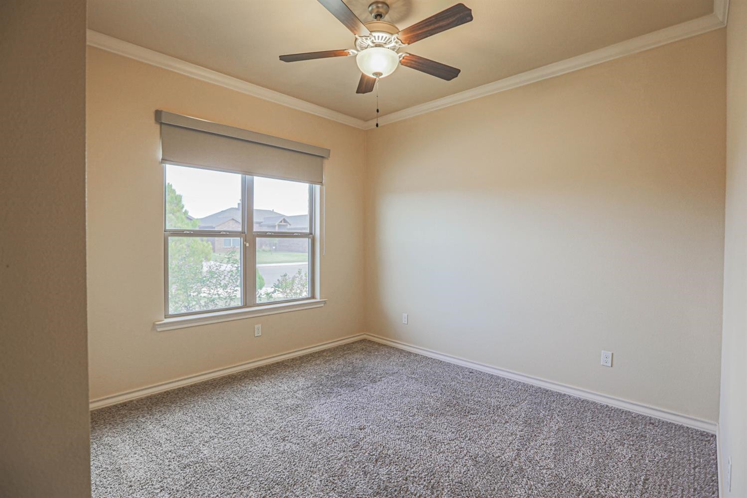 5019 Jarvis Street Lubbock, TX 79416 - Photo 17 of 31 an empty room with a window and a fan