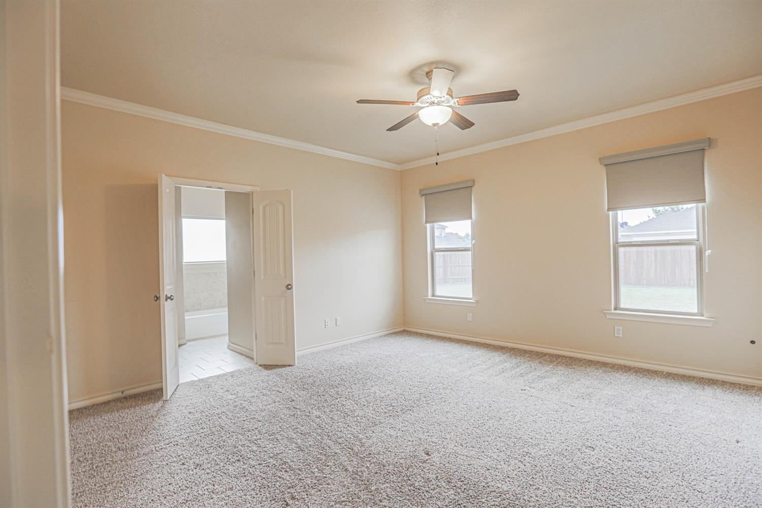 5019 Jarvis Street Lubbock, TX 79416 - Photo 20 of 31 an empty room with windows and fan