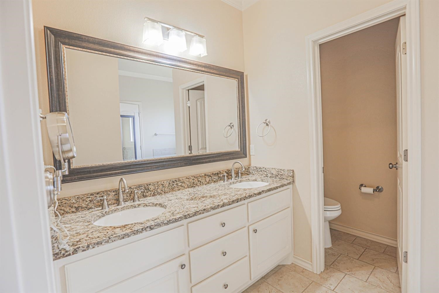 5019 Jarvis Street Lubbock, TX 79416 - Photo 22 of 31 a bathroom with a granite countertop sink and a mirror