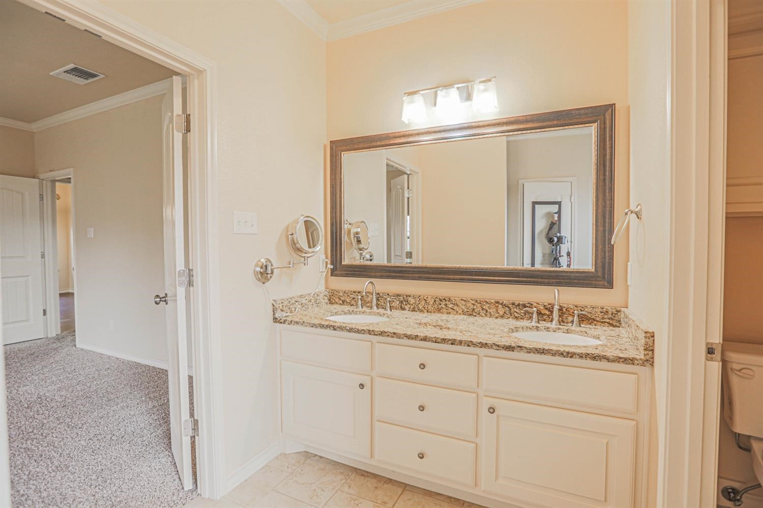5019 Jarvis Street Lubbock, TX 79416 - Photo 23 of 31 a bathroom with a sink vanity and a mirror