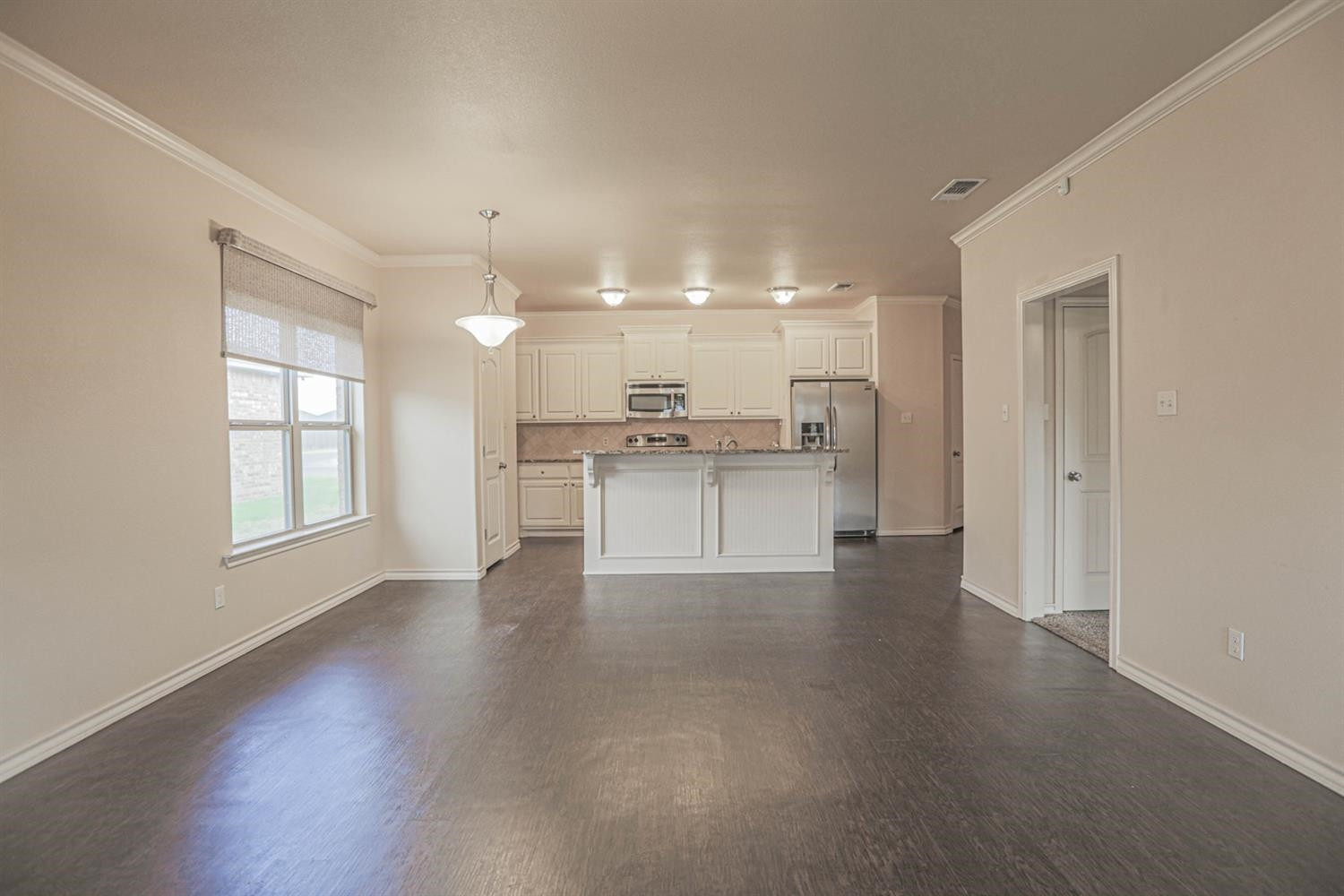 5019 Jarvis Street Lubbock, TX 79416 - Photo 8 of 31 a view of a kitchen with a stove cabinets and wooden floor