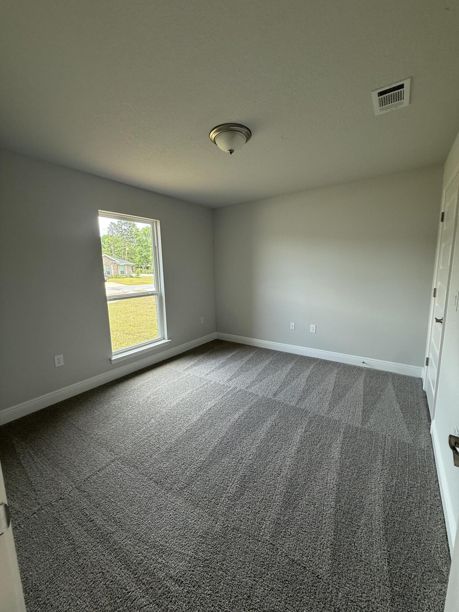 6002 Crocket Cove Crestview, FL 32539 - Photo 8 of 29 an empty room with windows