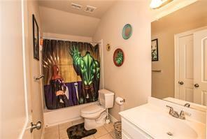 1409 Rosson Road Little Elm, TX 75068 - Photo 16 of 34 Full bathroom featuring a single vanity with an integrated sink, a toilet, and a combination shower/tub