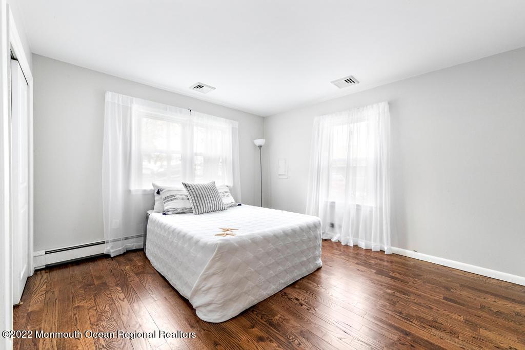 3 George Road Toms River, NJ 08753 - Photo 14 of 24 a bedroom with a large bed and wooden floor