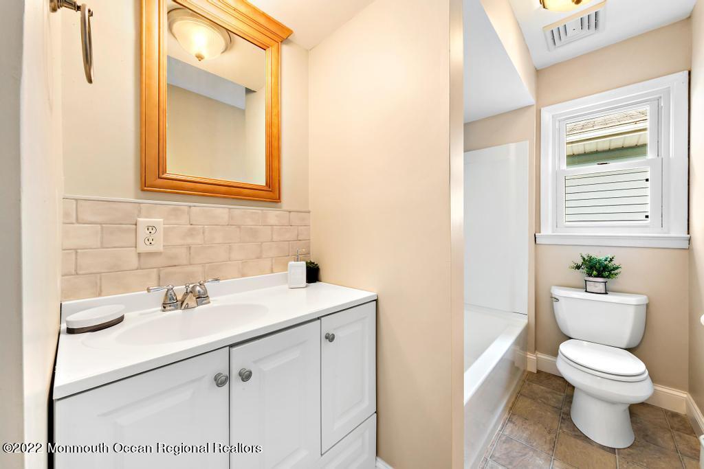 3 George Road Toms River, NJ 08753 - Photo 18 of 24 a bathroom with a toilet sink and mirror
