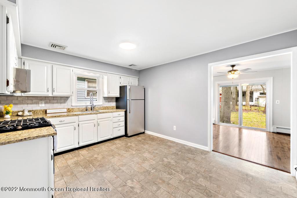 3 George Road Toms River, NJ 08753 - Photo 7 of 24 a kitchen with stainless steel appliances granite countertop a stove a sink and a refrigerator