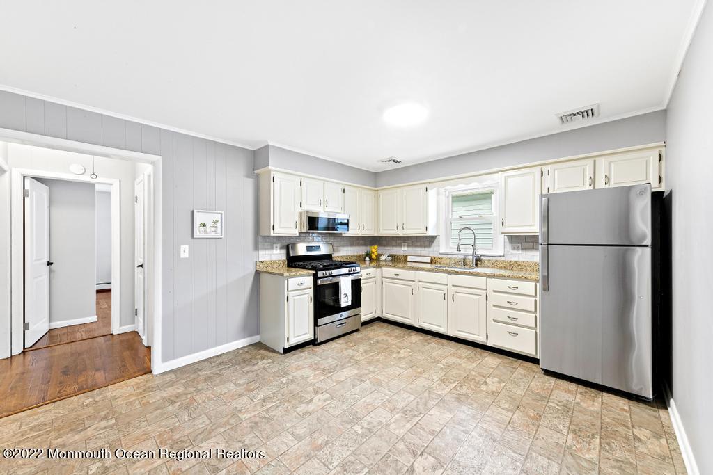 3 George Road Toms River, NJ 08753 - Photo 9 of 24 a kitchen with a refrigerator and white cabinets