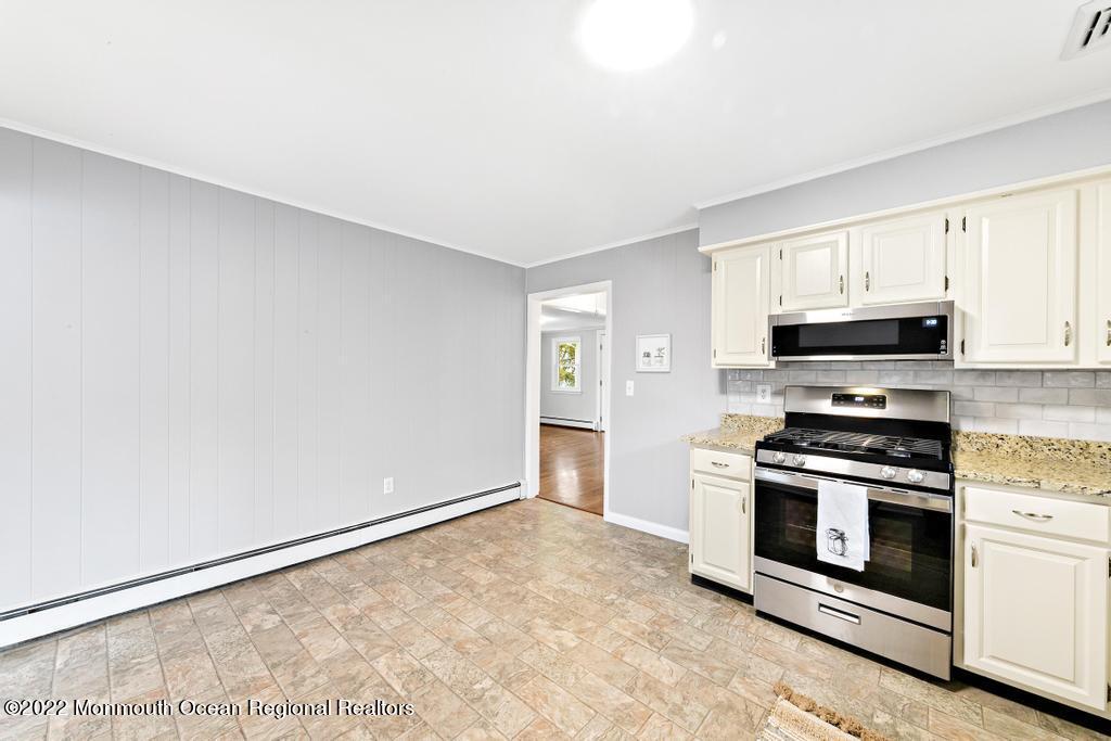 3 George Road Toms River, NJ 08753 - Photo 10 of 24 a kitchen with granite countertop a stove top oven and cabinets