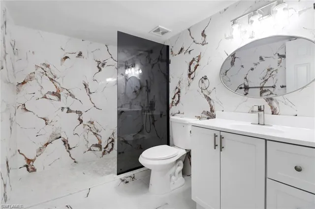 a bathroom with a sink toilet and shower