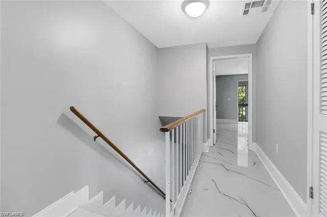 a view of a hallway with wooden floor and entryway