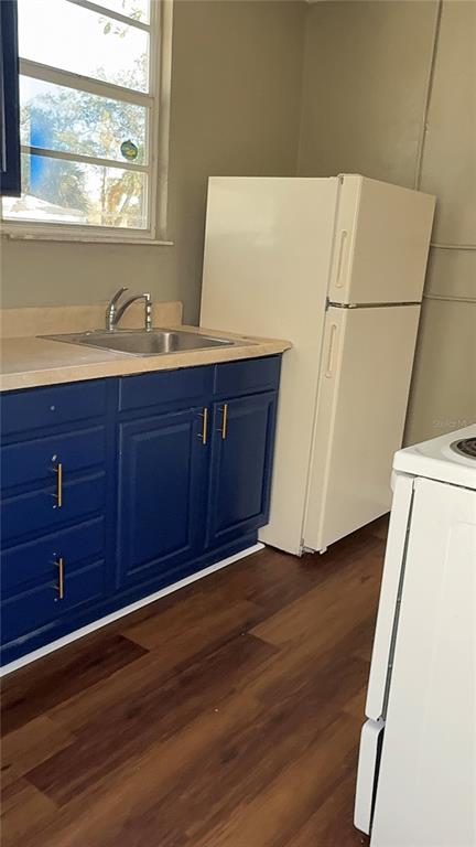 1101 South Ridgewood Avenue Daytona Beach, FL 32114 - Photo 20 of 37 a view of a kitchen with wooden floor and electronic appliances