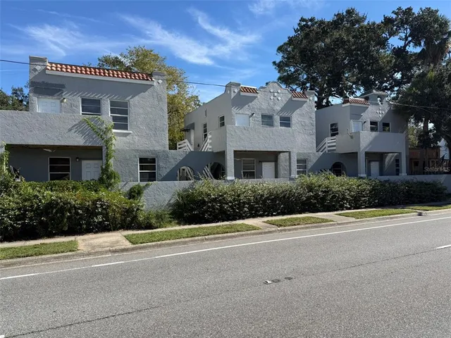 a front view of a house with a yard and a garage