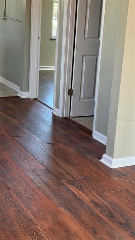 1101 South Ridgewood Avenue Daytona Beach, FL 32114 - Photo 21 of 37 a view of a hallway in a house with wooden floor