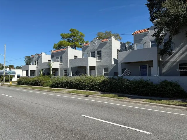 a view of a street with a building in the background