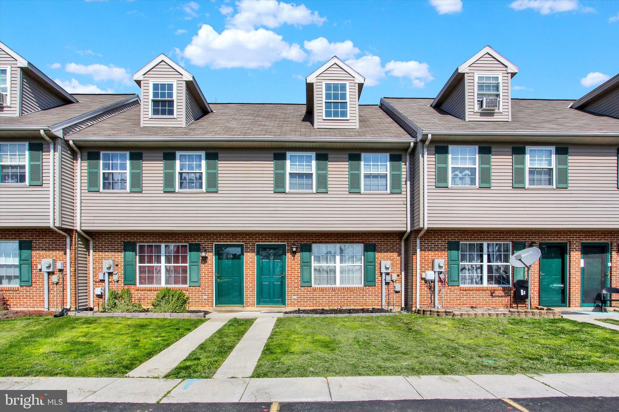 117 Orchard Lane, Unit 12 Hanover, PA 17331 - Photo 2 of 23 a front view of a house with a yard