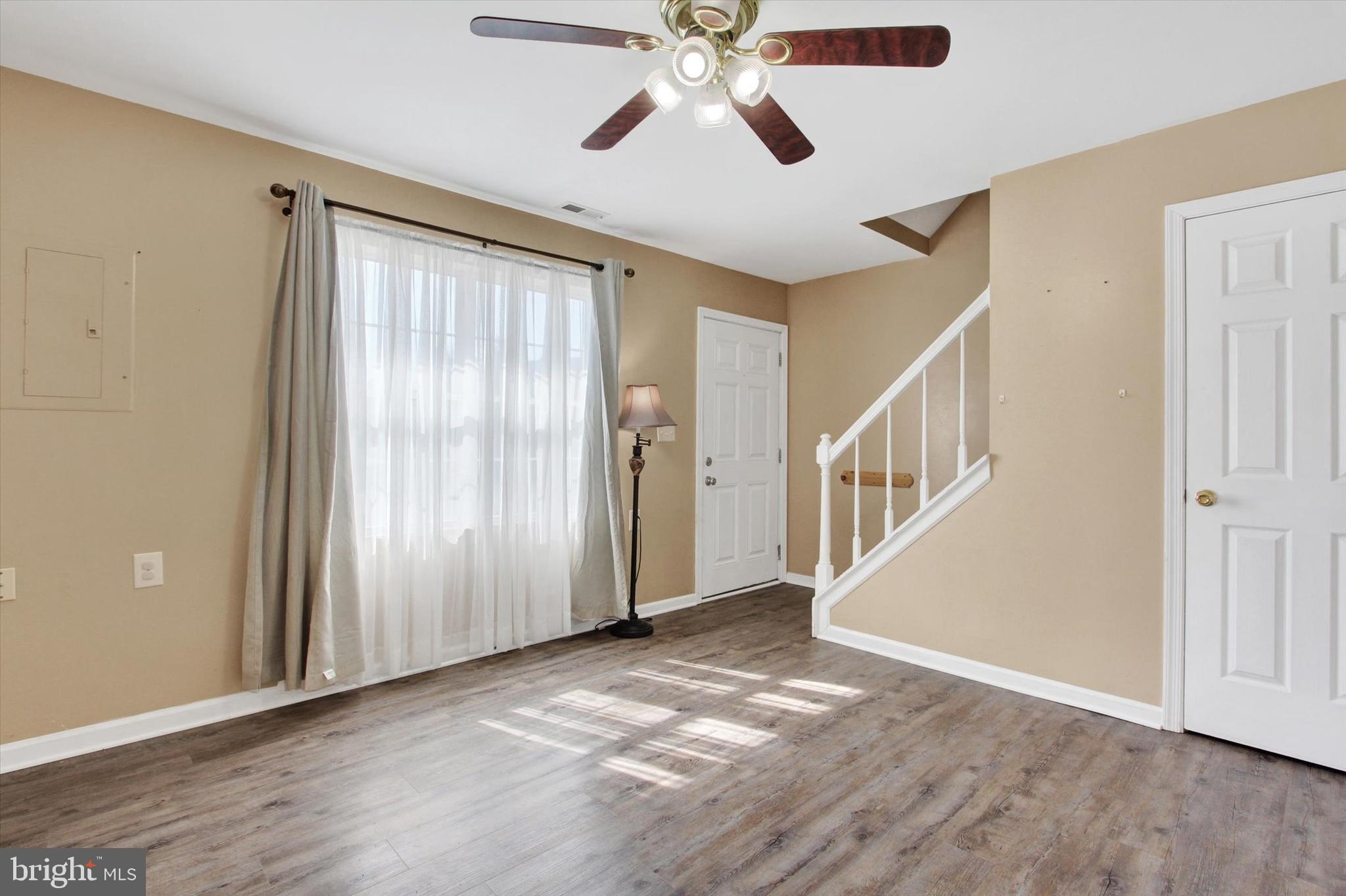117 Orchard Lane, Unit 12 Hanover, PA 17331 - Photo 3 of 23 a view of an empty room with wooden floor and a window