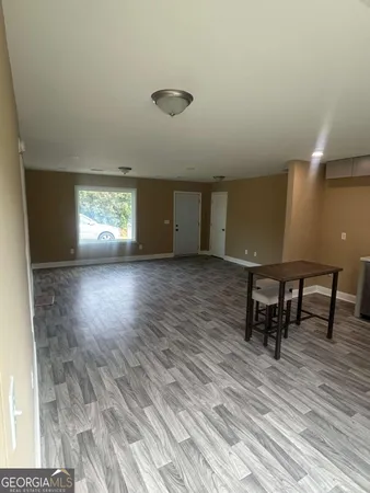 a view of a room with wooden floor and windows