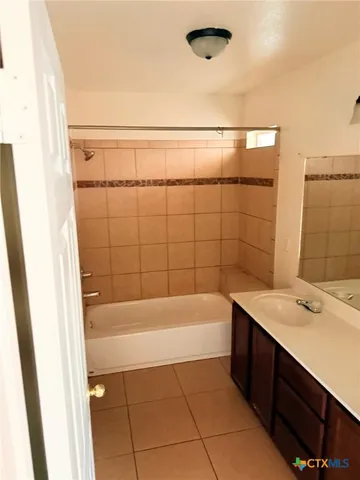a bathroom with a bathtub and shower