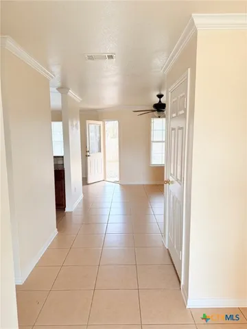 a view of a hallway with wooden floor and a bathroom