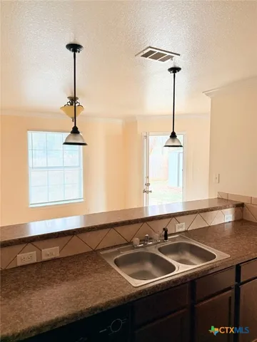 a bathroom with a sink and a window