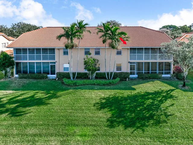 aerial view of a house with a yard and furniture