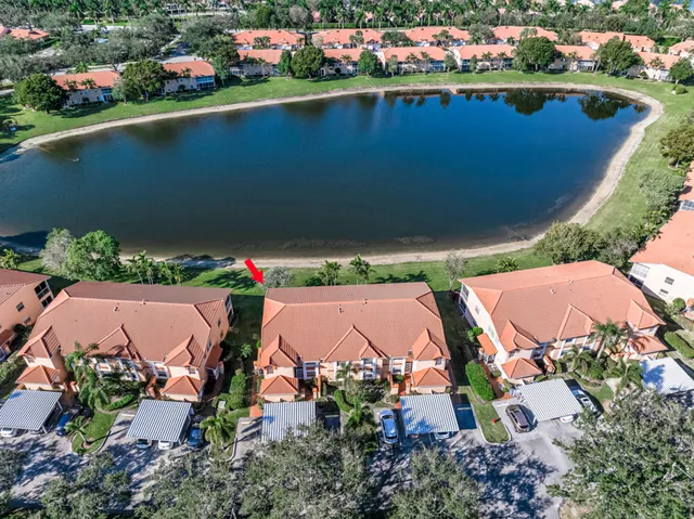 an aerial view of a house with garden space and street view