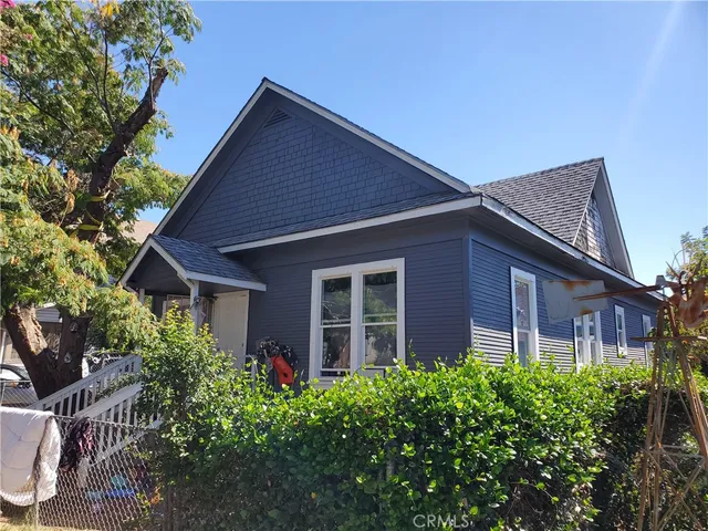 a brick house with potted plants in front of it