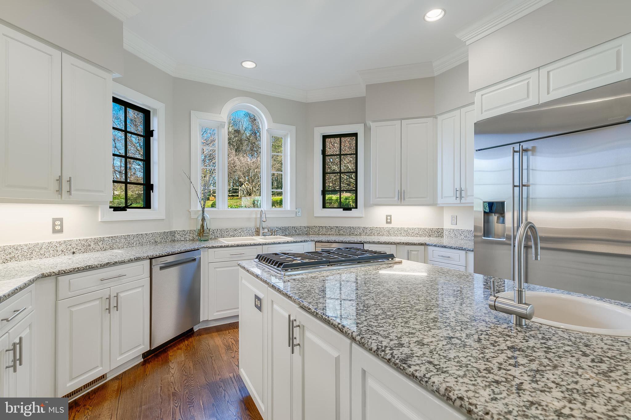 15140 Loyalty Road Waterford, VA 20197 - Photo 17 of 60 a kitchen with stainless steel appliances granite countertop a sink stove and cabinets